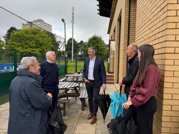 Daniel Szor and colleagues outside a sports pitch with Street League staff
