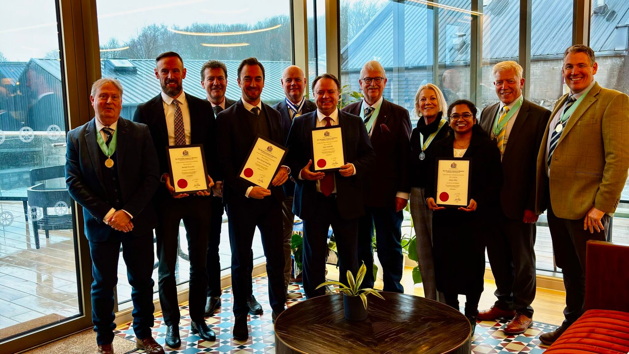 New Freemen holding their freedom certificates at Glencadam Distillery