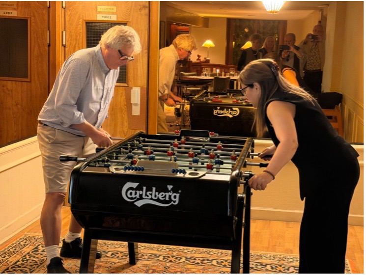 The Mistress and the Immediate Past Master playing table football