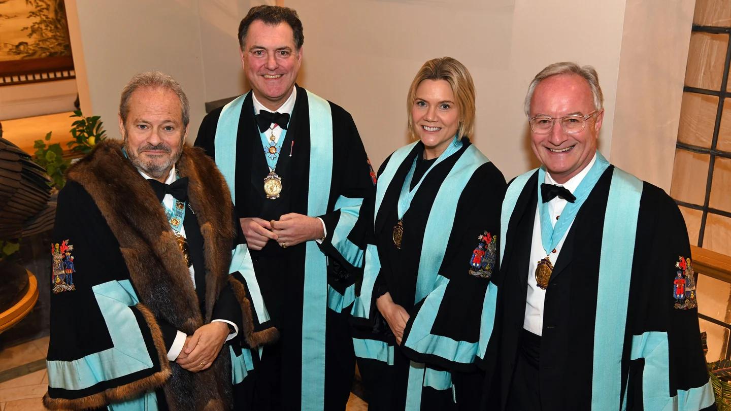 Company officers in ceremonial gowns at an installation.