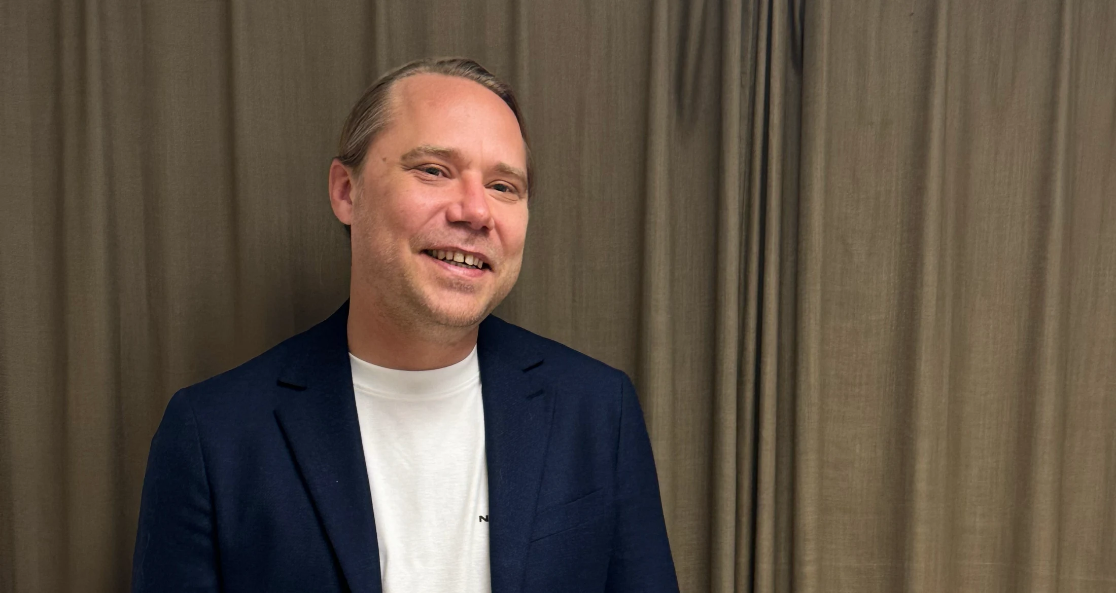 Christian posing in front of golden background