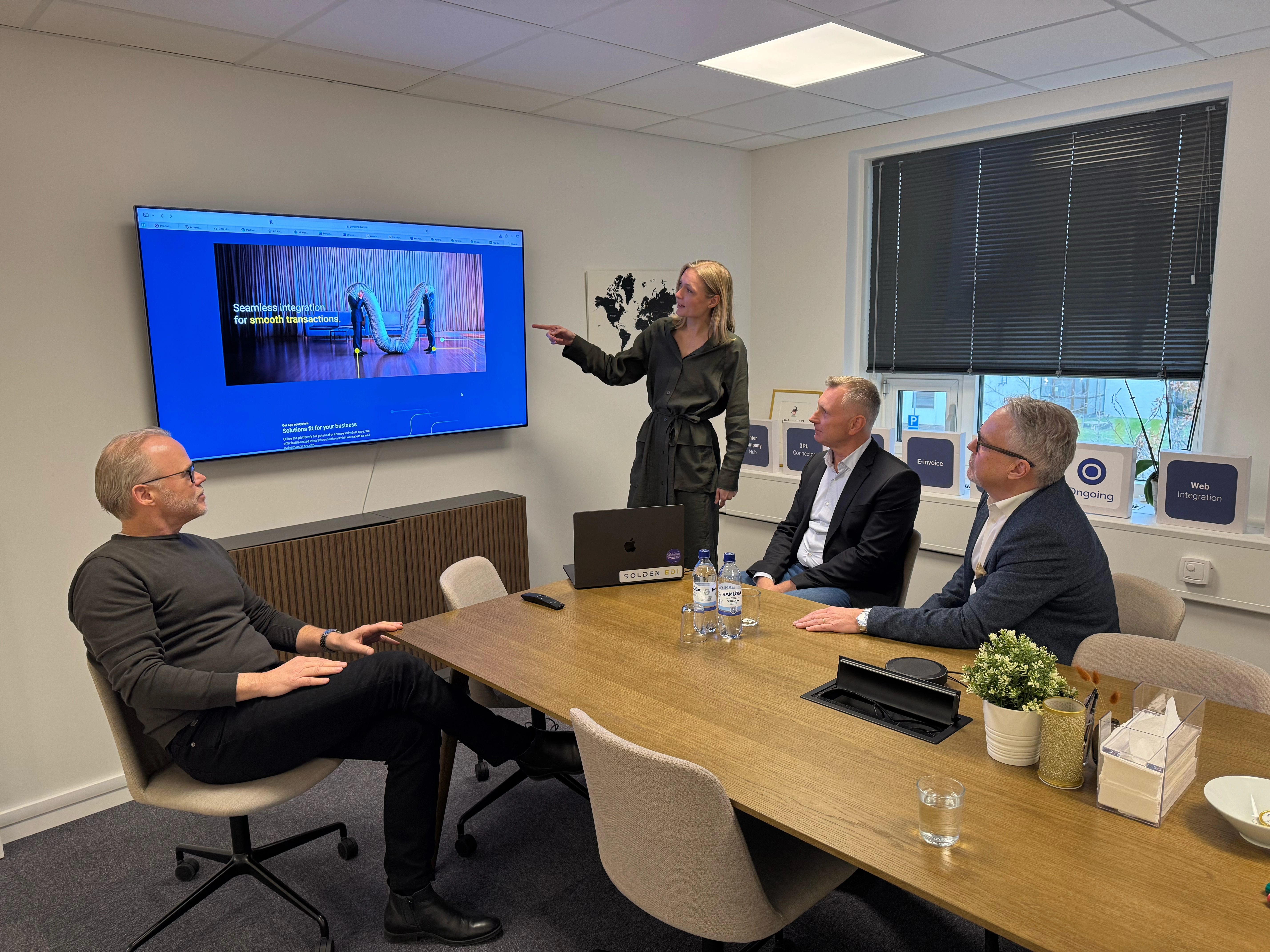 Picture of Christian Jönsson, Elin Pira (presenting), Johan Adenmark and Mats Persson in the conference room. 