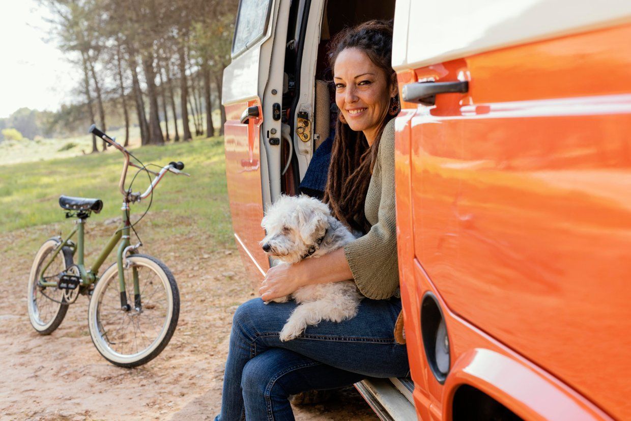 Mobile groomer with a dog beside their van