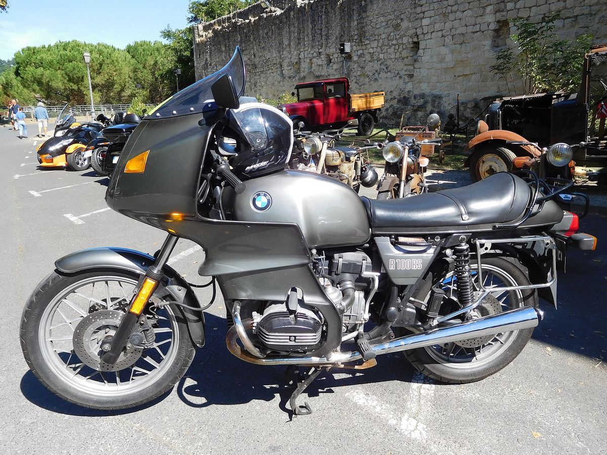 Silver BMW R100RS with its rider's helmet, photographed outdoors in recent years