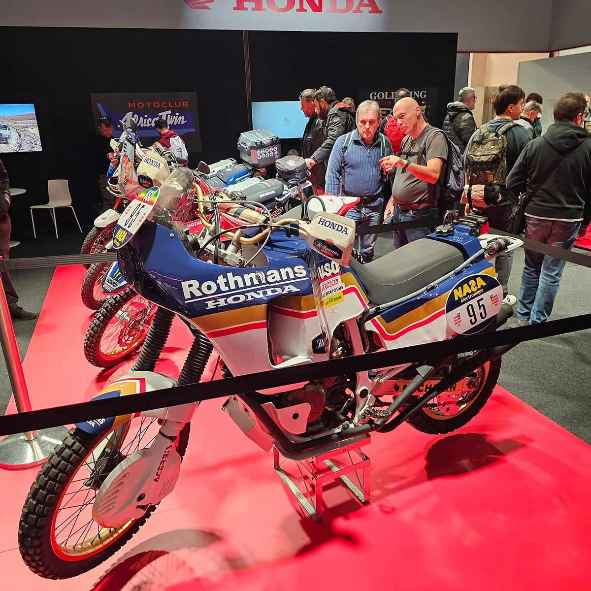 Blue and white Honda NXR750 works rally bike in Rothmans colours on display at a motorcycle show