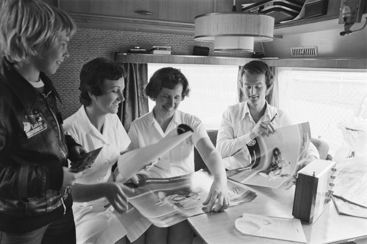 Wil Hartog signing autographs for Red Cross nurses during practice at Assen, June 1977
