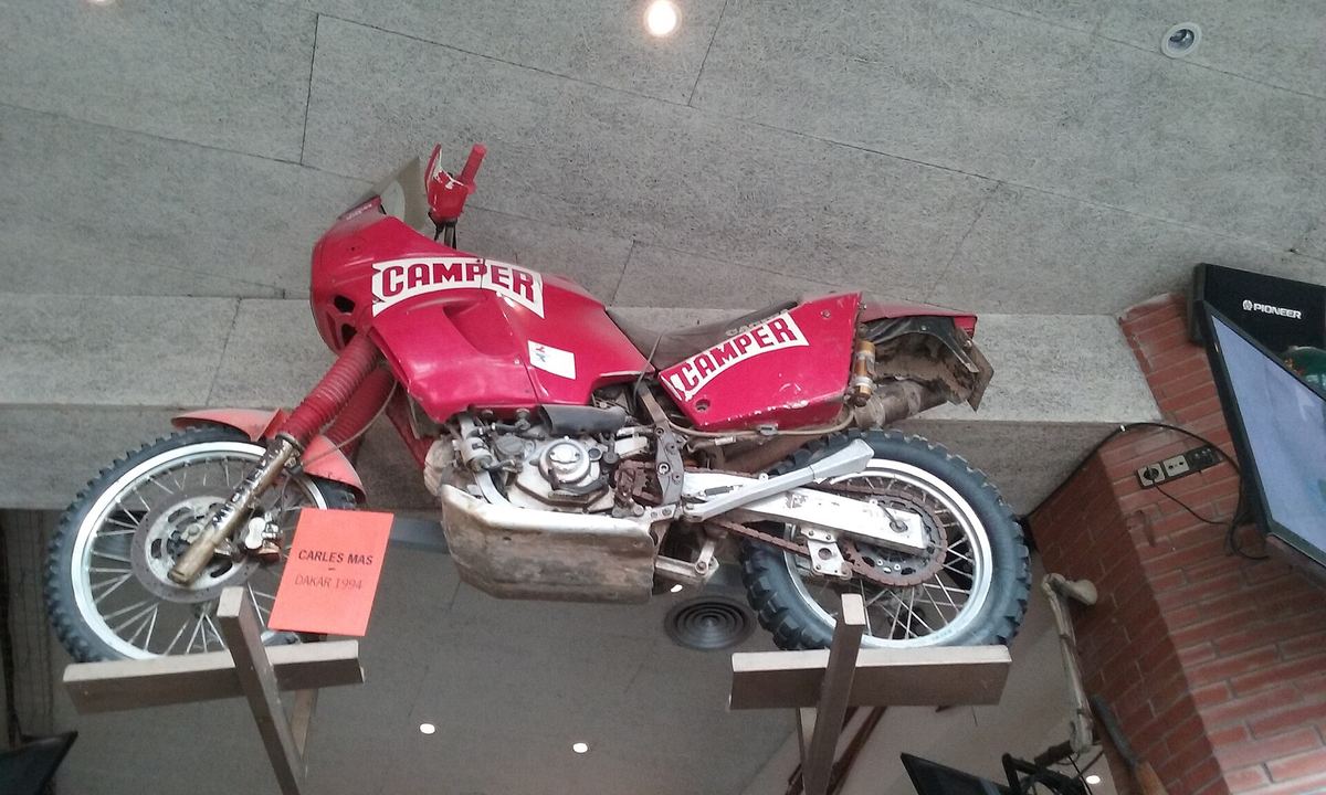 Red Cagiva rally bike with Camper sponsorship, ridden by Carles Mas in the 1994 Paris–Dakar, on display