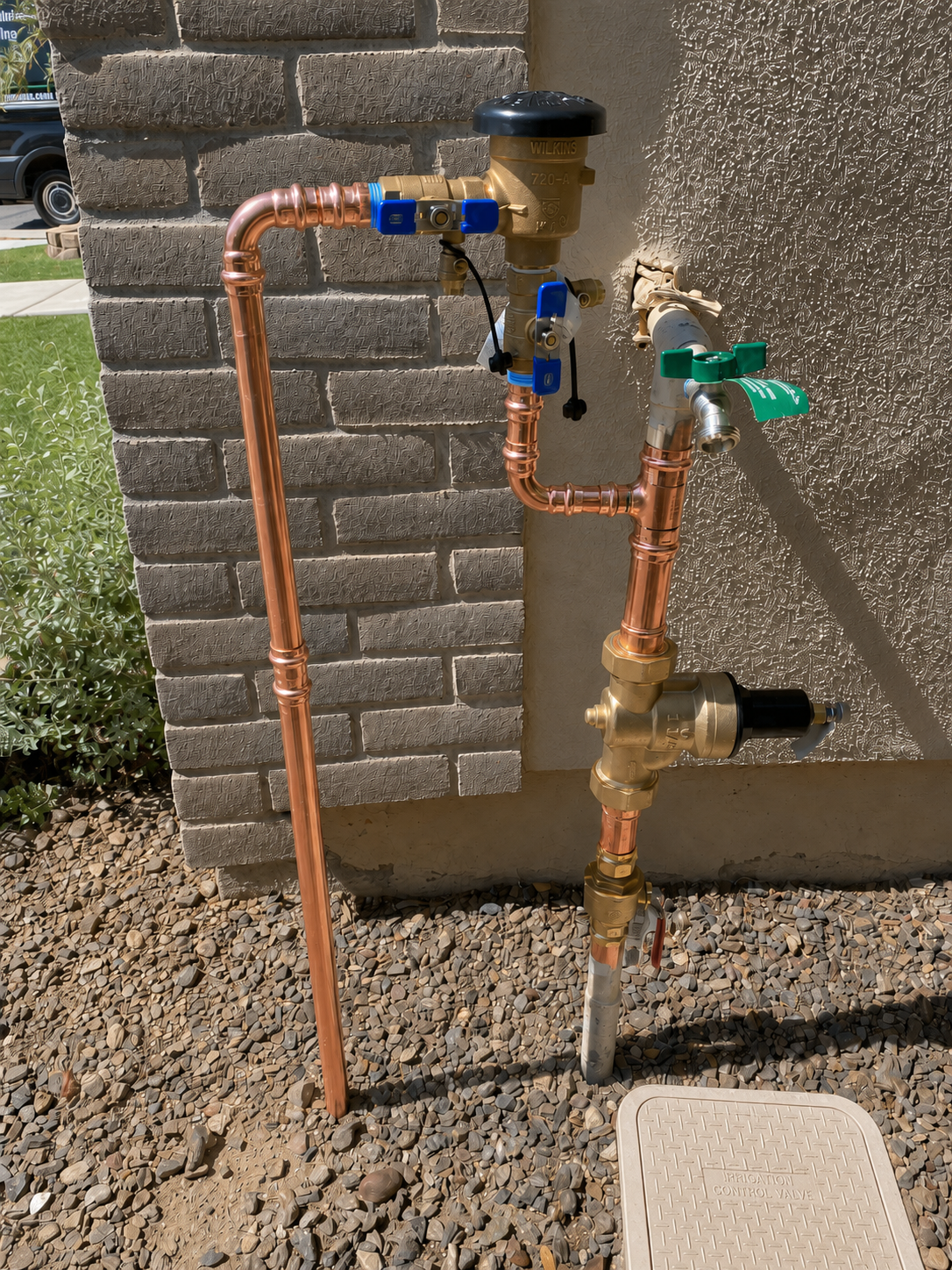 A complete rebuilt water service entry on a Phoenix home by Local Roots: new copper riser, quarter-turn ball valve main shutoff, pressure regulator, anti-siphon hose bib, and irrigation take-off with backflow preventer