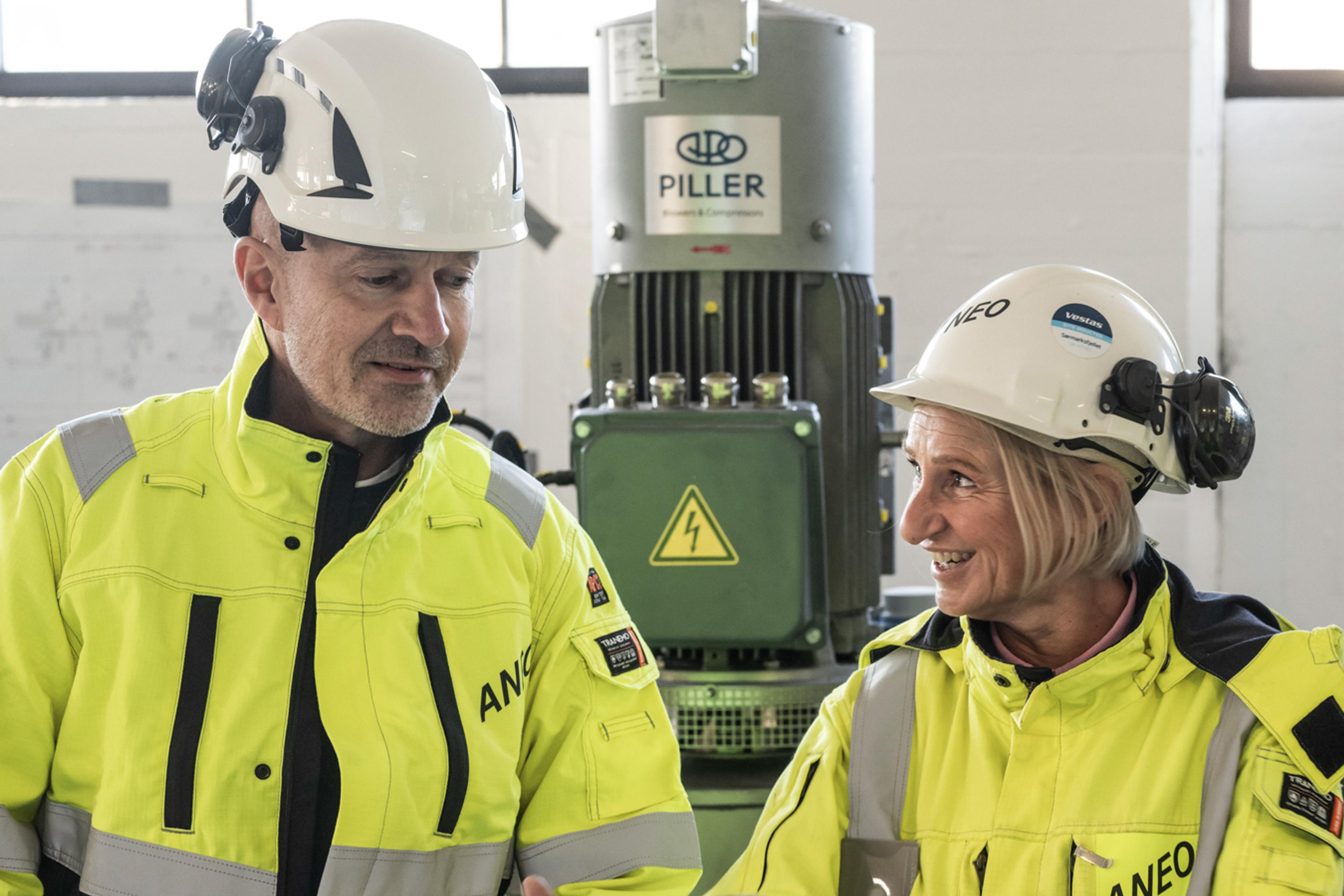 Three members of the Aneo Industry team standing with our Frigg system