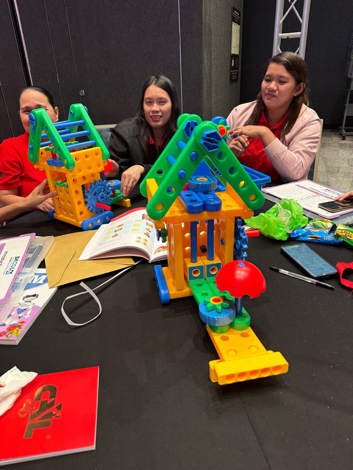 Teachers building kit models together at a training day