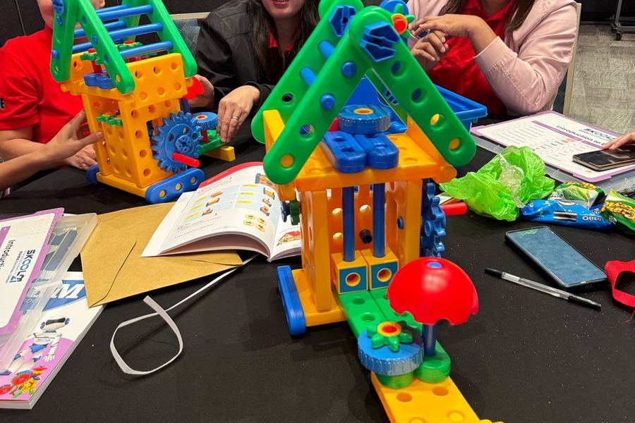 Teachers building kit models together at a training day