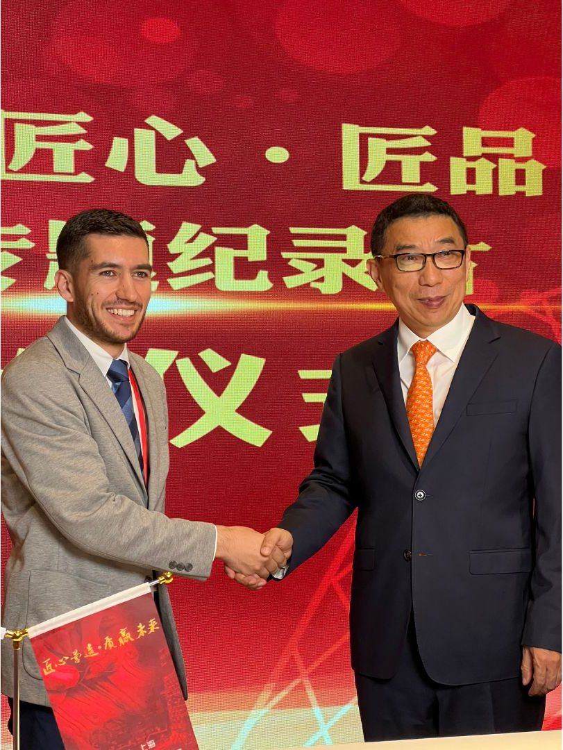 Syed Shawal shaking hands with a CCTV China representative at the Shanghai International Book Fair 2024