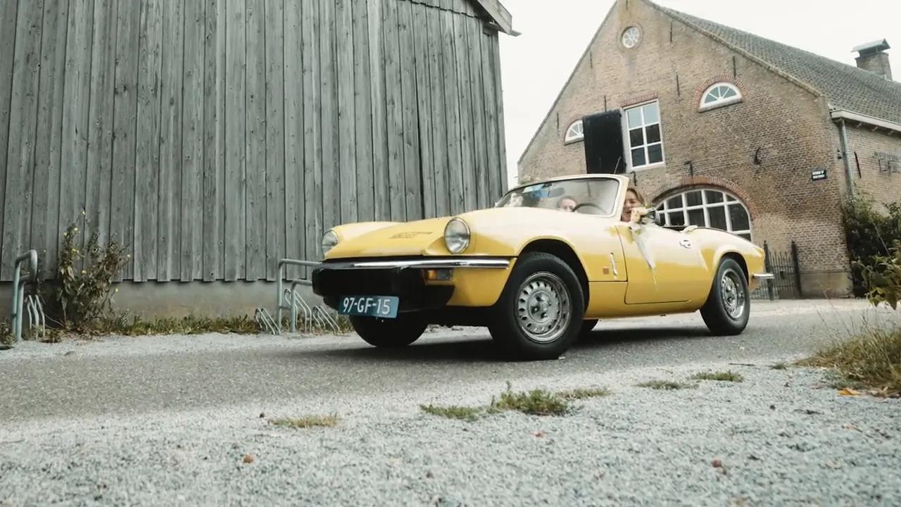 Yellow wedding car by a barn