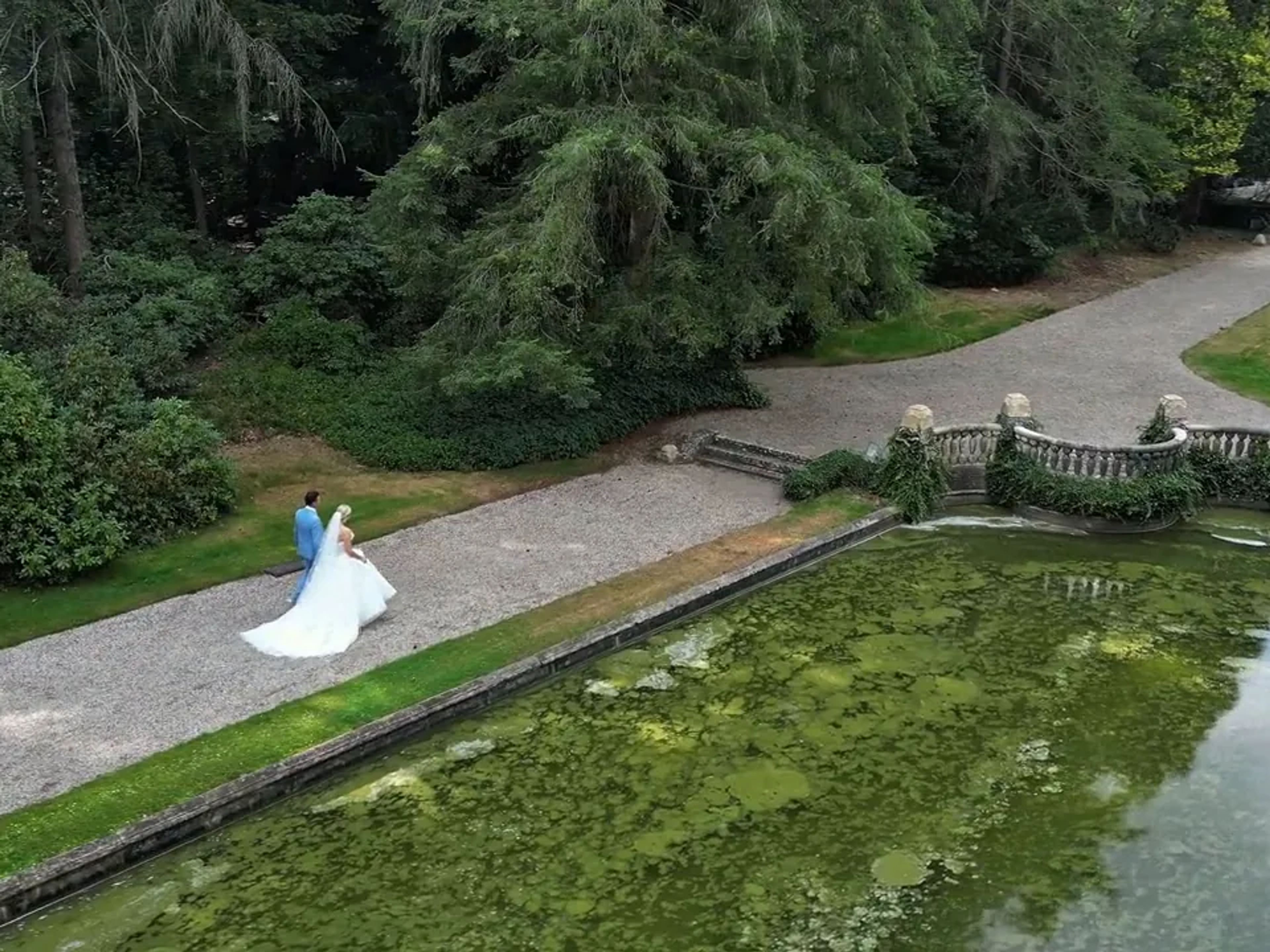 Couple along a pond, from above