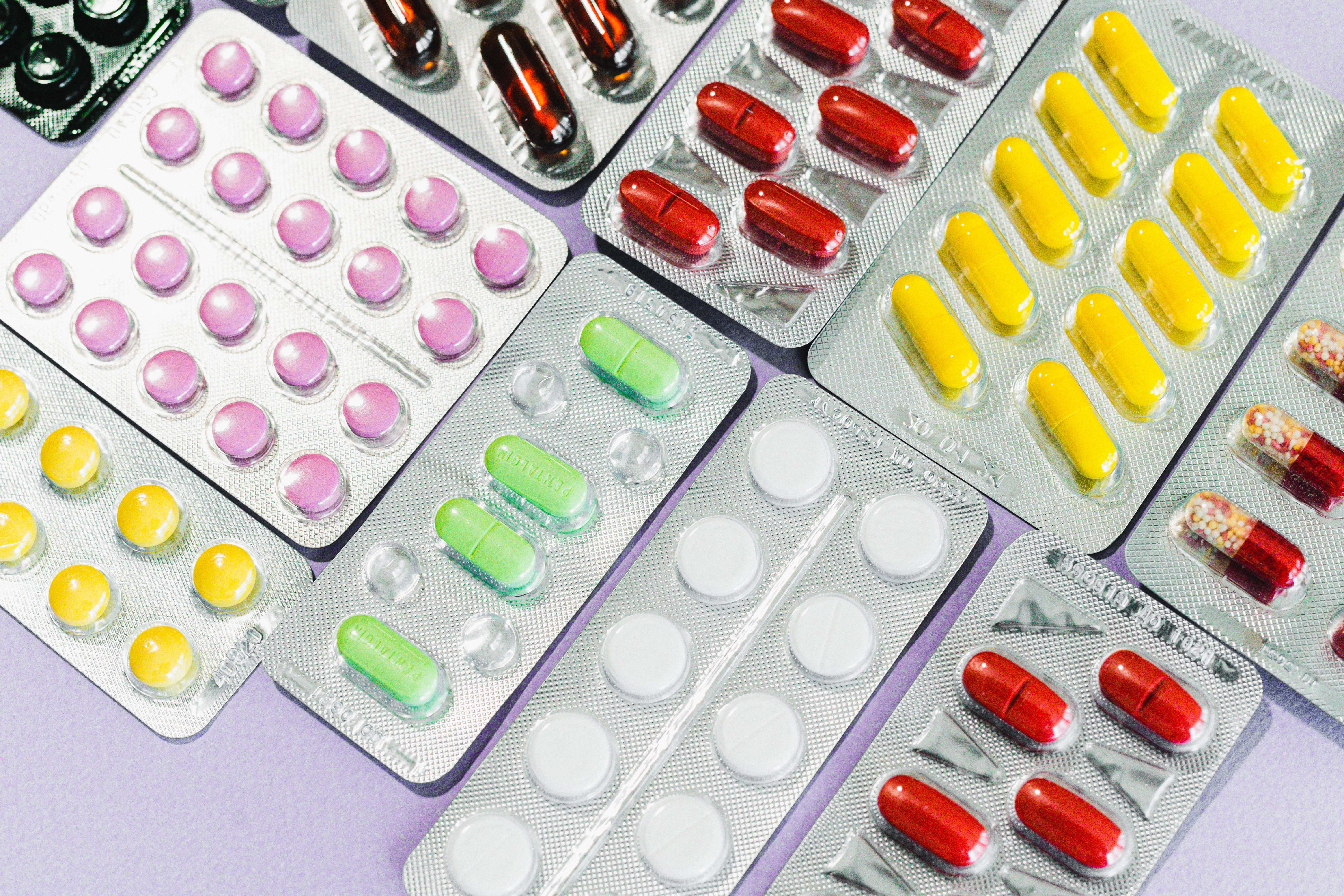 Blister packs of colorful pills and capsules, illustrating the risk of prescription errors at a New Jersey pharmacy.