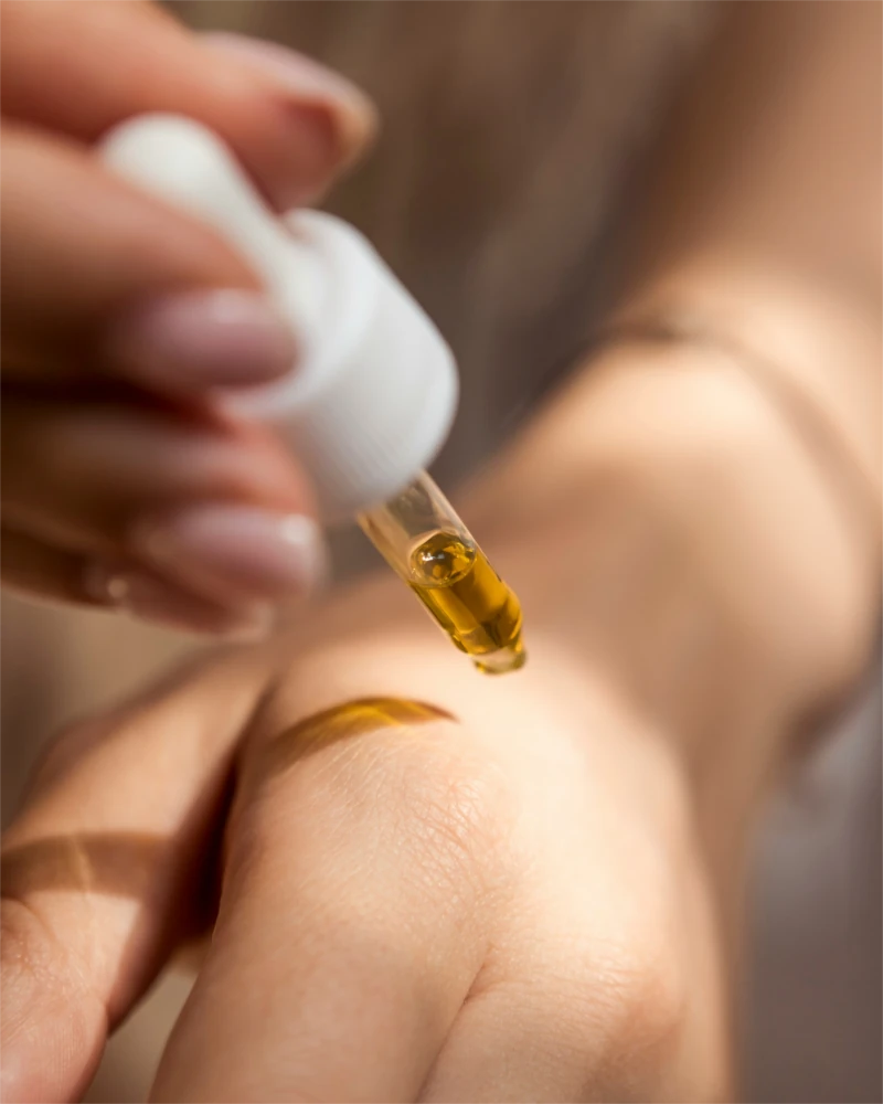 Olive oil being applied to the skin with a pipette.