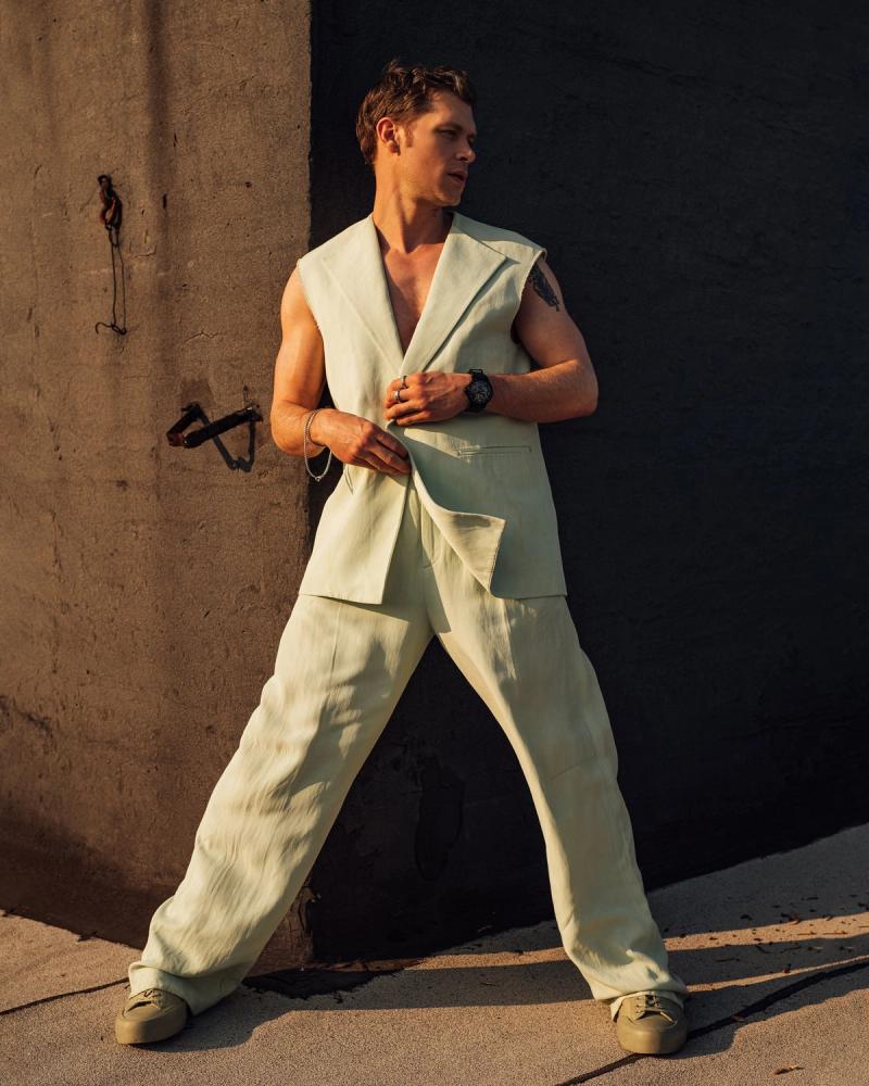 Actor Joseph Morgan, wearing a modern pale suit without sleeves, photographed for Numéro Netherlands shot by photographer Taylor Miller.