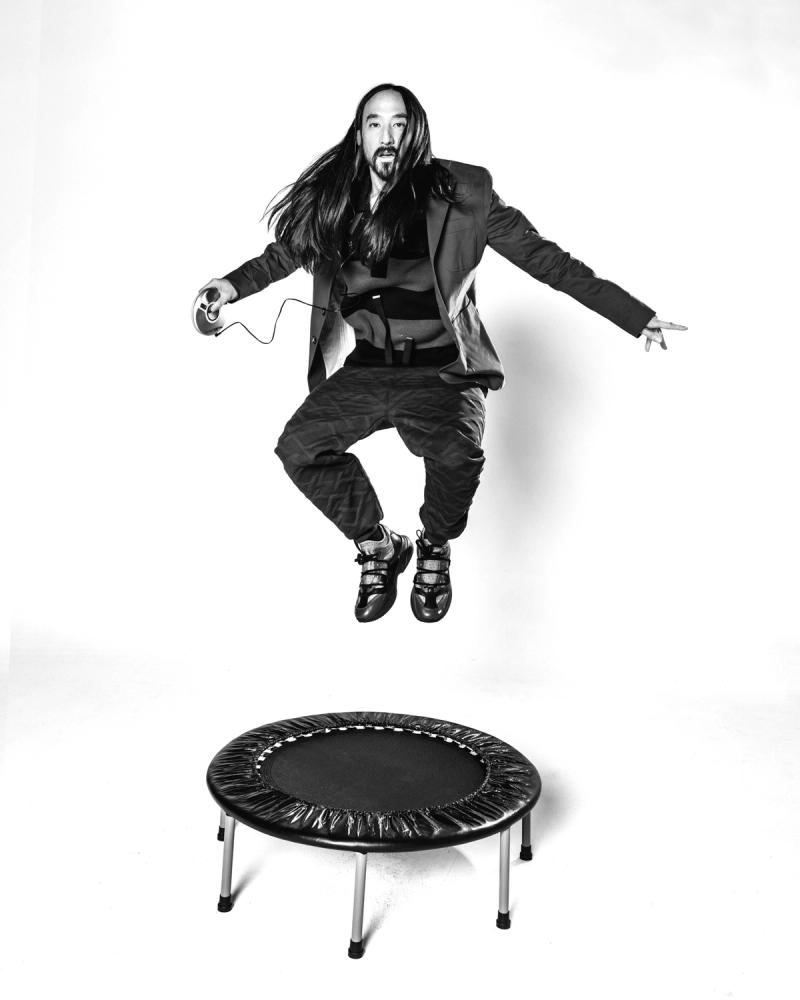 Steve Aoki, wearing a Tommy Hilfiger Jacket and Pants and bouncing on a trampoline, photographed for Complex and Tommy Hilfiger by photographer Taylor Miller.