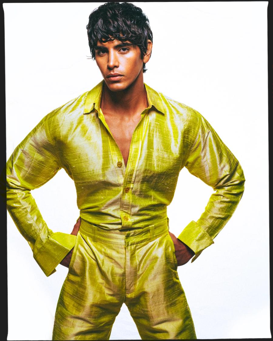 Model Sergio Perdomo, wearing a yellow shirt and pants, photographed for Numéro Netherlands shot by photographer Taylor Miller.