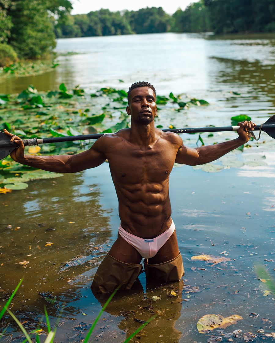 Model Joshua Cummings, posing in a river, photographed for L'Officiel Hommes shot by photographer Taylor Miller.