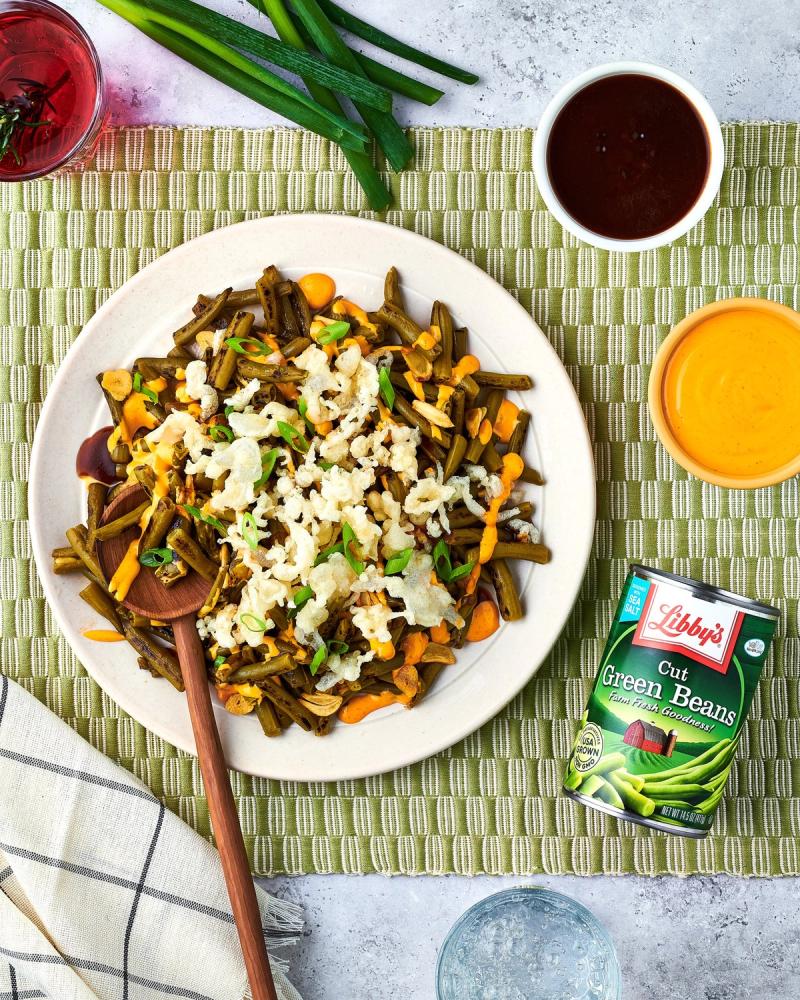 Plate of green beans, carrots and rice beside a Libby's Cut Green Beans can on a green striped mat, for Libby's and BuzzFeed by Taylor Miller.