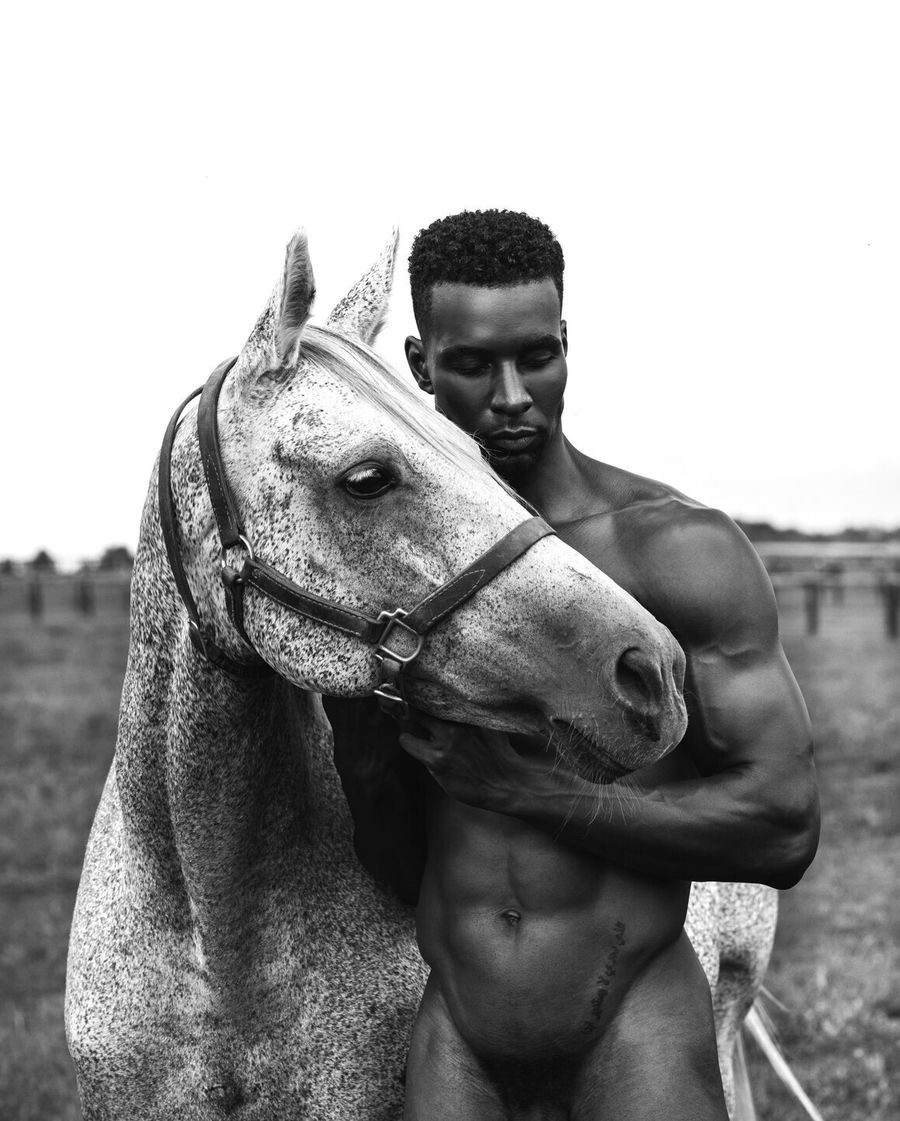 Model Joshua Cummings, posing with a horse, photographed for L'Officiel Hommes shot by photographer Taylor Miller.