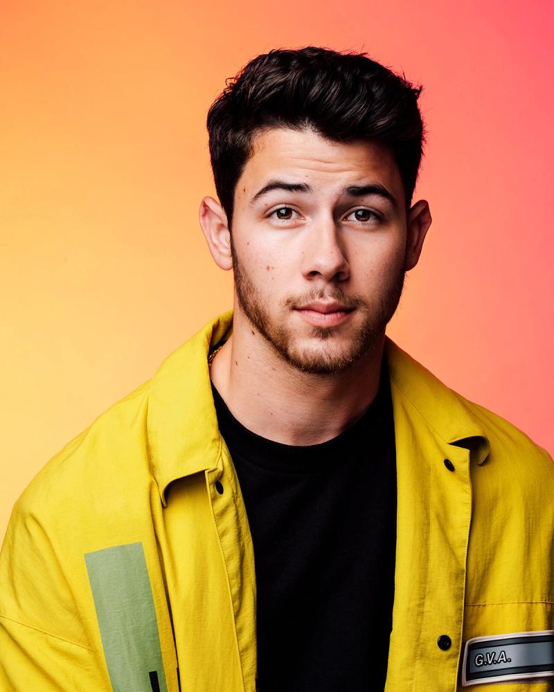 Singer Nick Jonas, wearing a bright yellow jacket, photographed in New York City by fashion and celebrity photographer Taylor Miller who is located in Brooklyn, NY. 