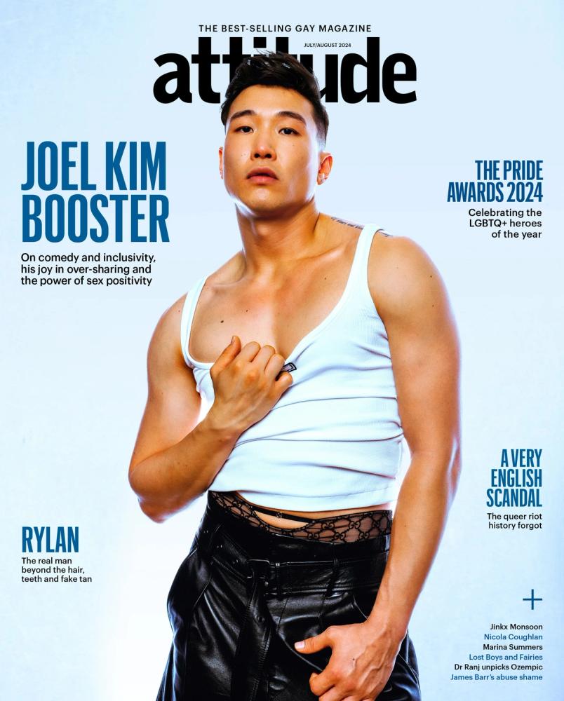 Joel Kim Booster on the cover of Attitude magazine in a white tank top and black leather trousers, photographed by Taylor Miller.