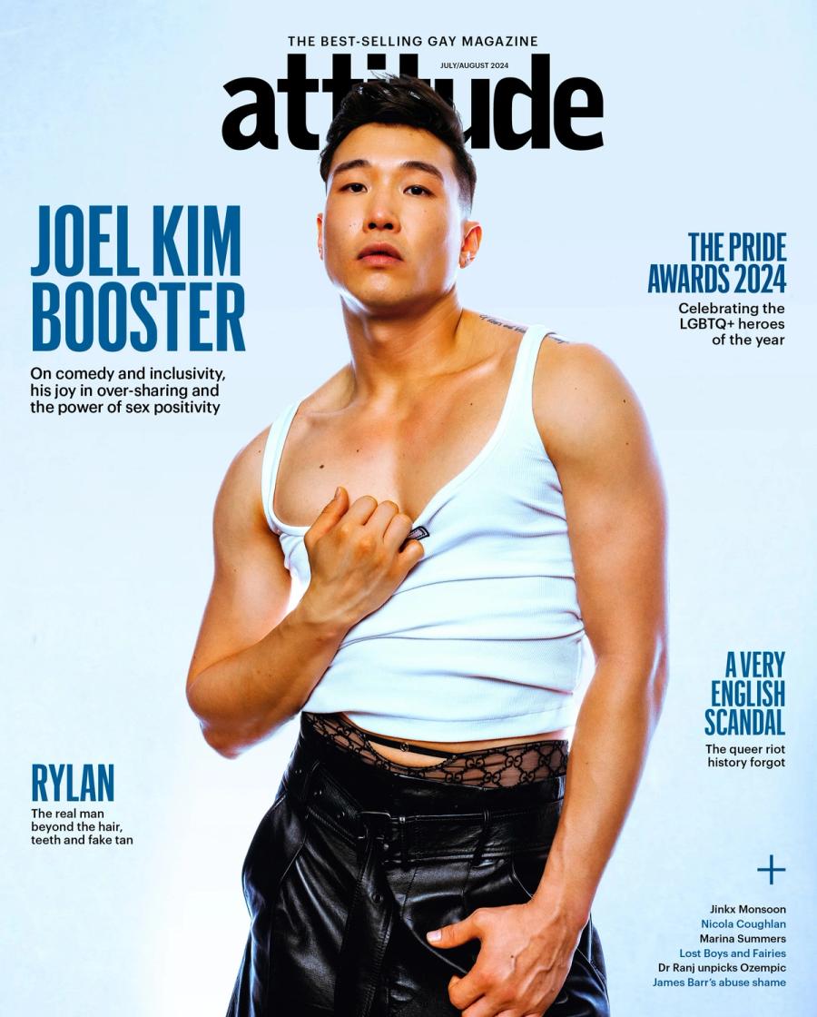 Joel Kim Booster on the cover of Attitude magazine in a white tank top and black leather trousers, photographed by Taylor Miller.
