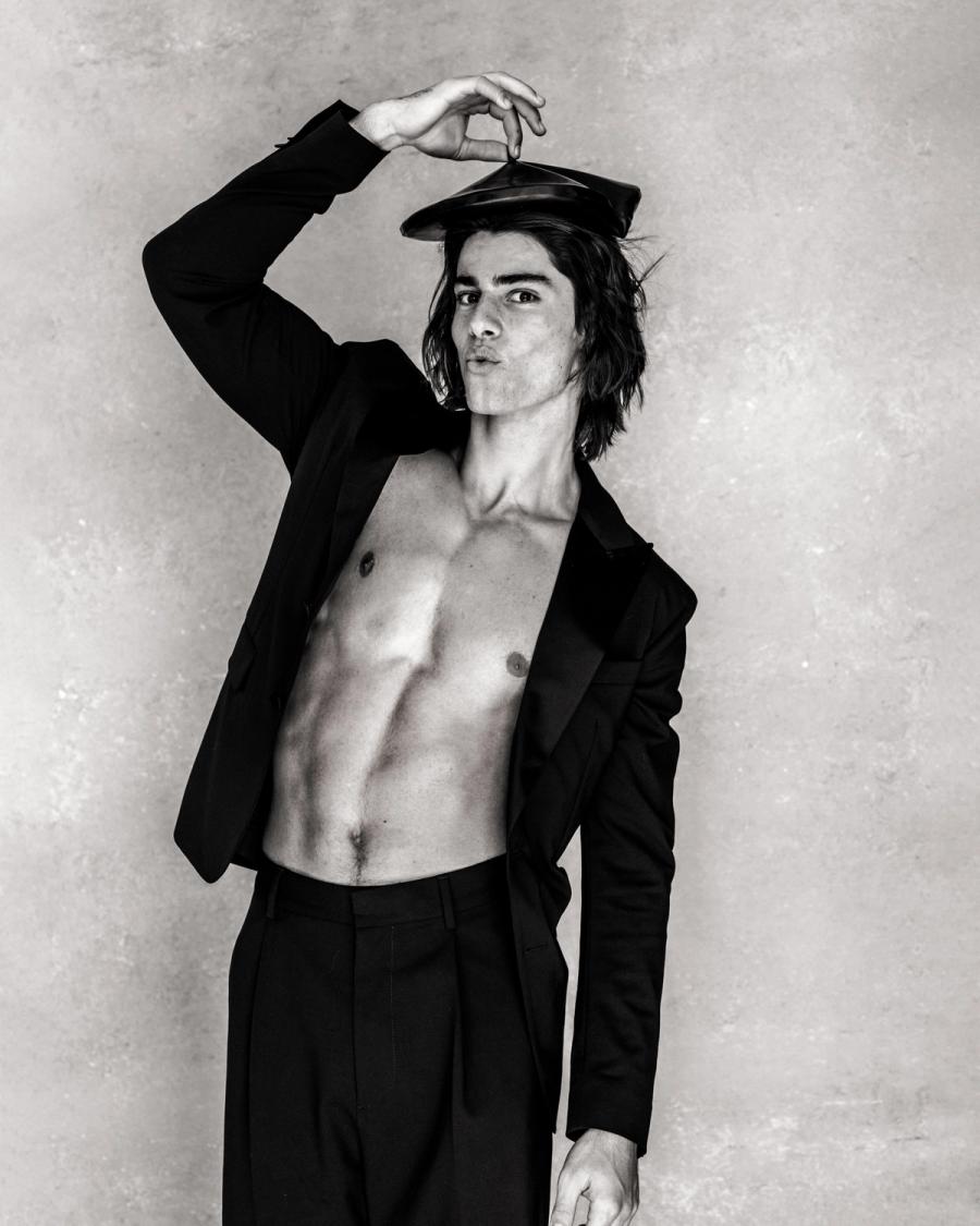Model Corrado Martini, wearing a black shirt and pants with a baret, photographed for L'Officiel Hommes Poland shot by photographer Taylor Miller.