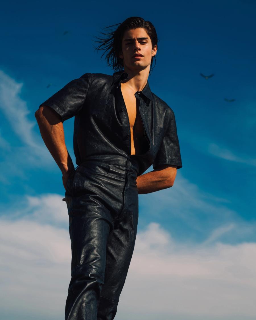 Model Corrado Martini, wearing a navy leather shirt and pants, photographed for L'Officiel Hommes Poland shot by photographer Taylor Miller.