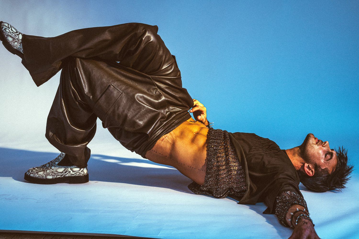 Model Christian Hogue, wearing a sweater and pants, photographed for Numéro Netherlands shot by photographer Taylor Miller.