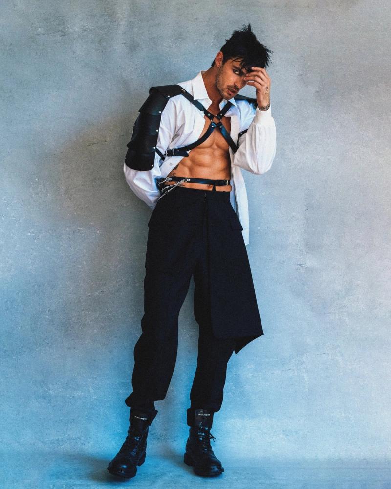 Model Christian Hogue, wearing a white shirt and harness, photographed for Numéro Netherlands shot by photographer Taylor Miller.