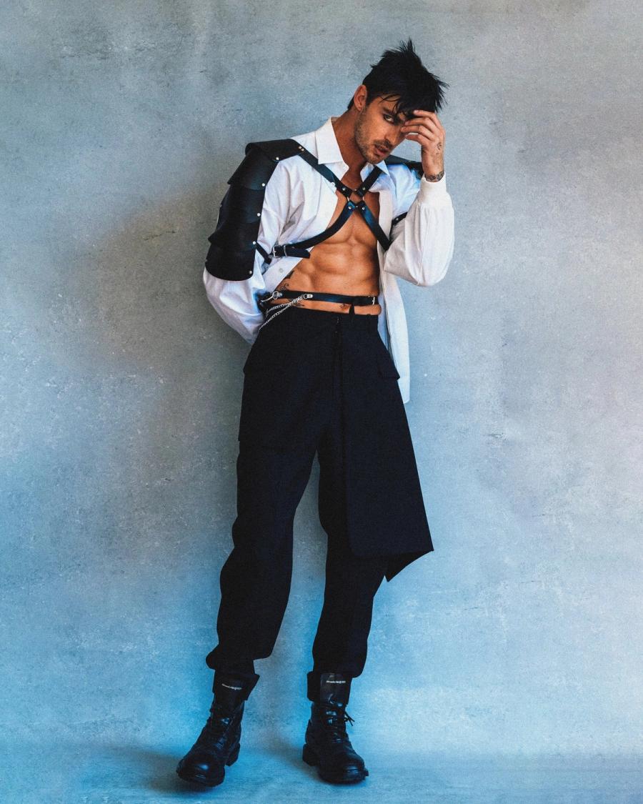 Model Christian Hogue, wearing a white shirt and harness, photographed for Numéro Netherlands shot by photographer Taylor Miller.