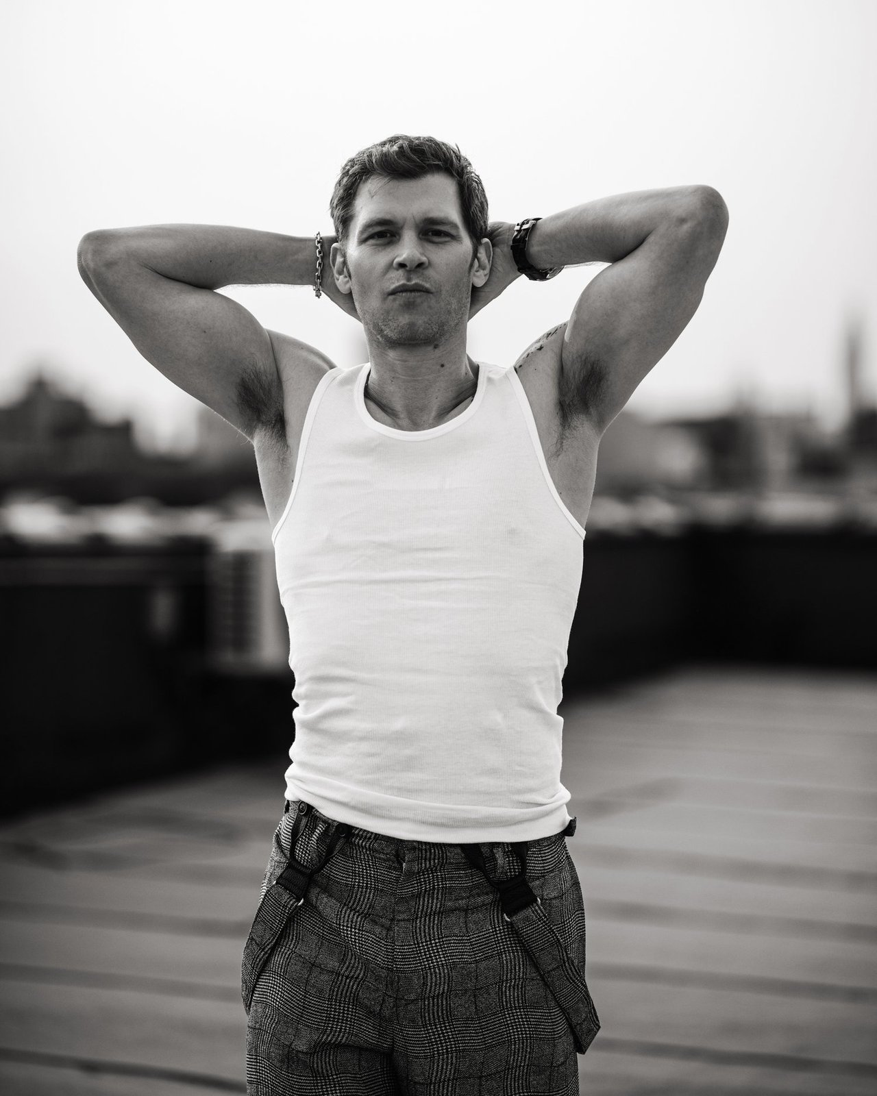 Actor Joseph Morgan, wearing a white tank top and grey patterned pants, photographed for Numéro Netherlands shot by photographer Taylor Miller.