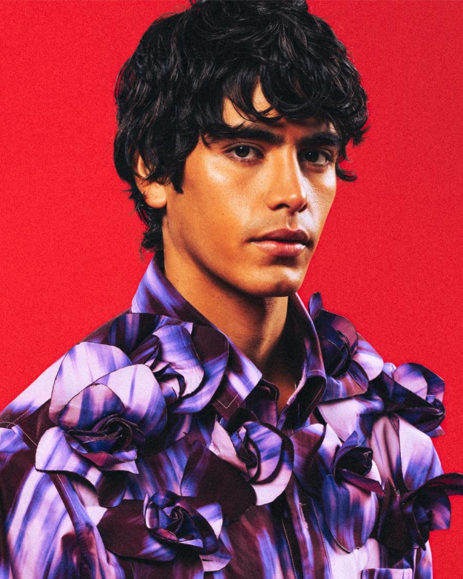 Model Sergio Perdomo, wearing a purple floral top, photographed for Numéro Netherlands shot by photographer Taylor Miller.