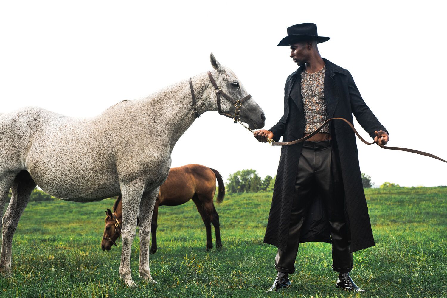 Model Joshua Cummings, posing with a horse, photographed for L'Officiel Hommes shot by photographer Taylor Miller.