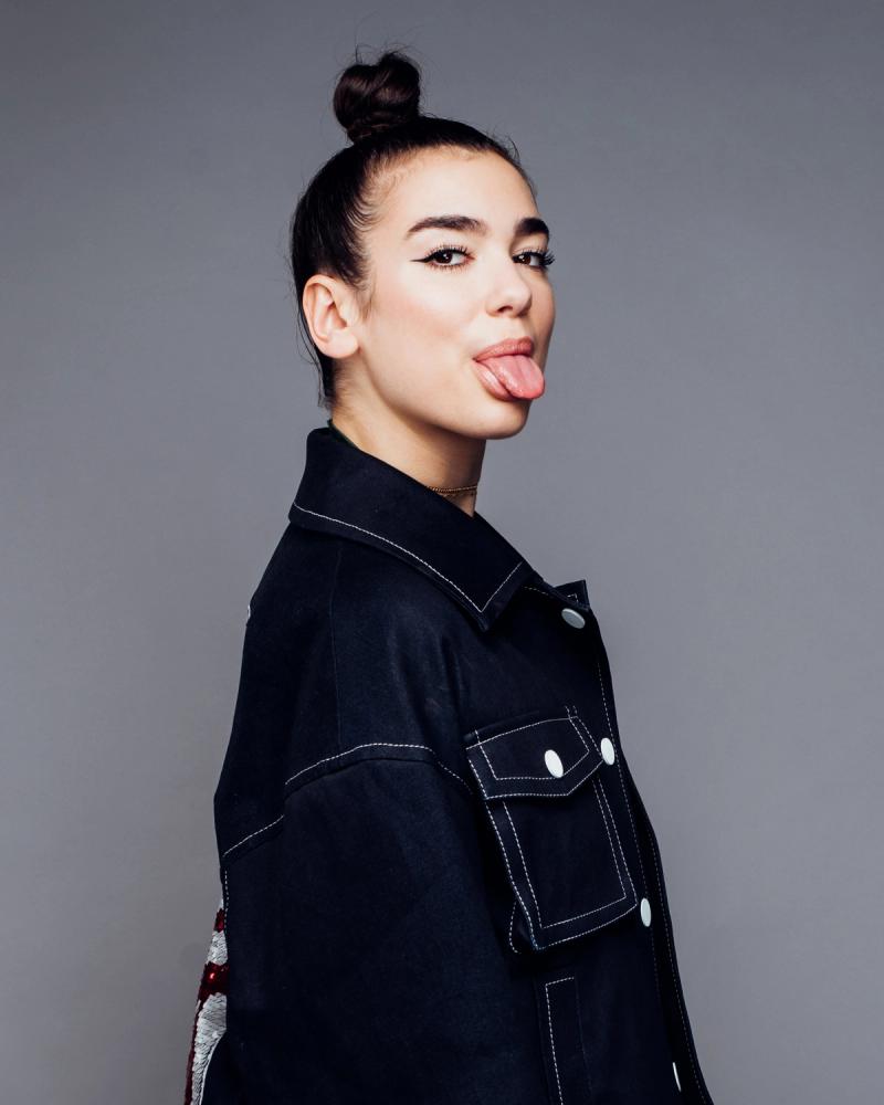 Superstar singer Dua Lipa, sticking her tongue out wearing a denim jacket, photographed in New York City by fashion and celebrity photographer Taylor Miller who is located in Brooklyn, NY. 