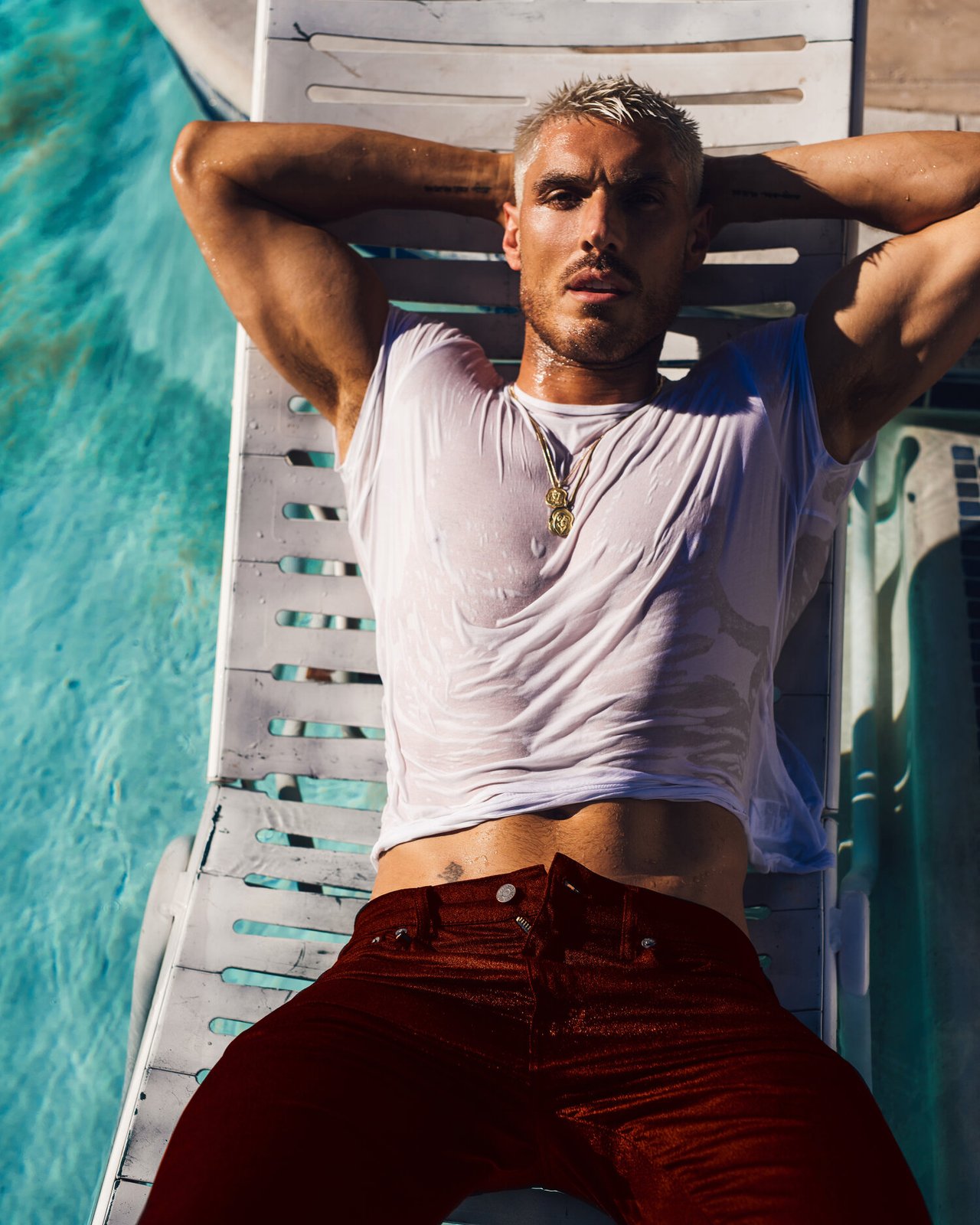 Celebrity Hairstylist Chris Appleton, posing on a chair in a pool, photographed in Palm Springs by fashion and celebrity photographer Taylor Miller who is located in Brooklyn, NY. 