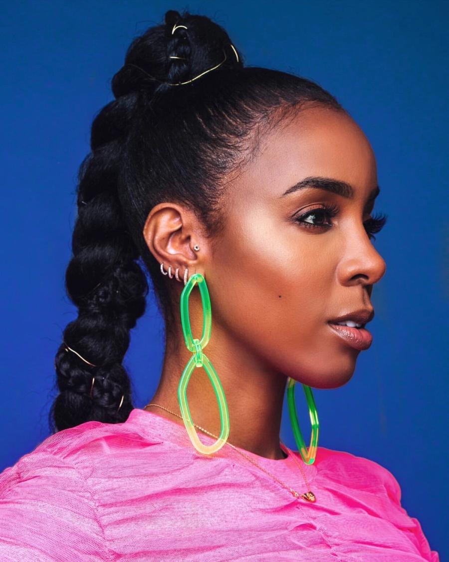 Singer Kelly Rowland, wearing a pink dress and neon green earrings, photographed in New York City by fashion and celebrity photographer Taylor Miller who is located in Brooklyn, NY. 