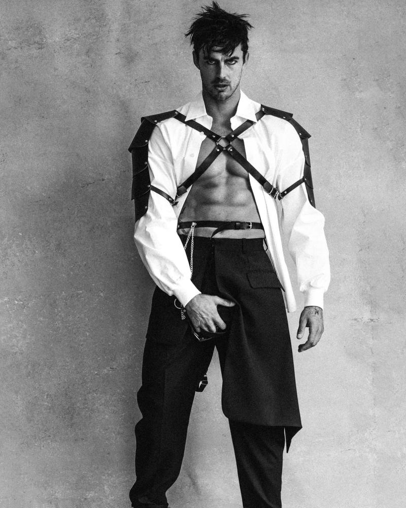Model Christian Hogue, wearing a white shirt and harness, photographed for Numéro Netherlands shot by photographer Taylor Miller.
