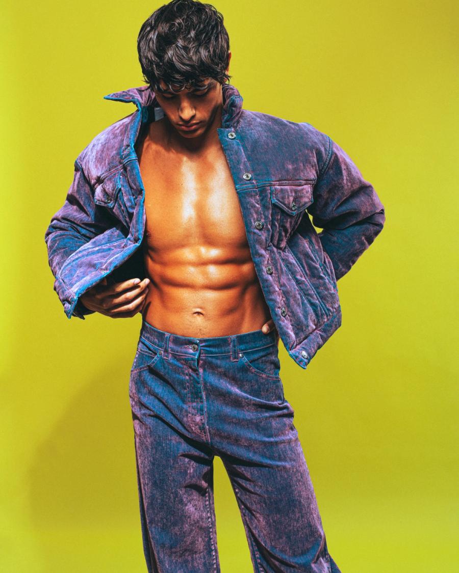 Model Sergio Perdomo, wearing a purple two piece outfit, photographed for Numéro Netherlands shot by photographer Taylor Miller.