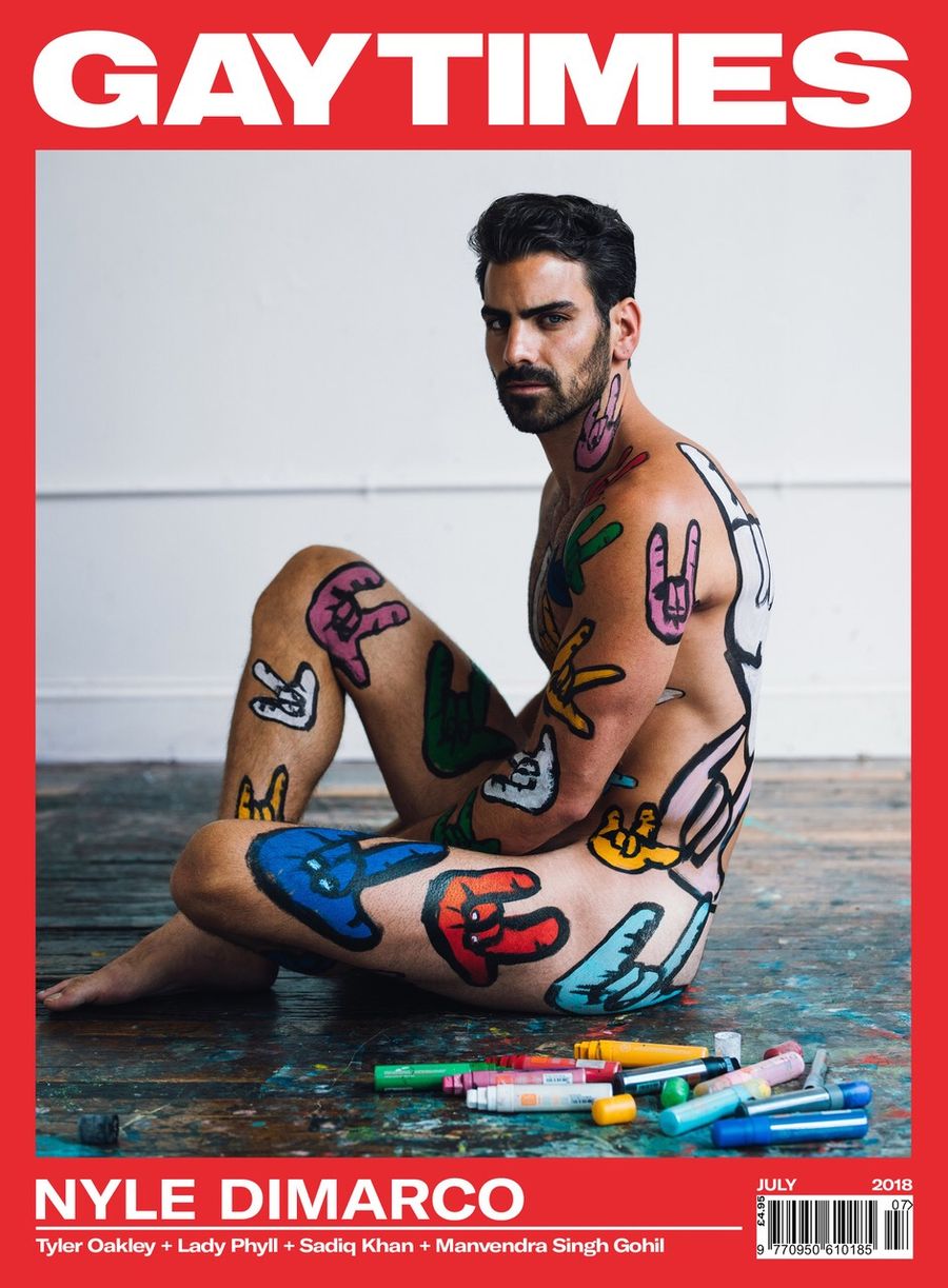 Nyle DiMarco seated nude with colorful sign-language hand art painted across his body on the cover of Gay Times, photographed by Taylor Miller.