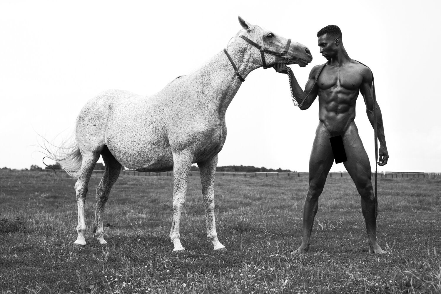 Model Joshua Cummings, posing with a horse, photographed for L'Officiel Hommes shot by photographer Taylor Miller.