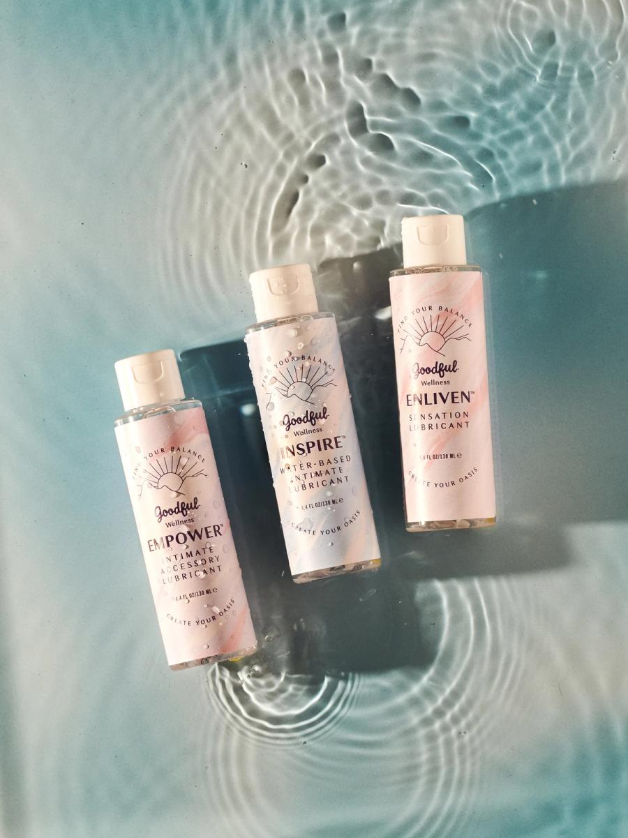 Three Goodful Wellness intimate lubricant bottles, Empower, Inspire and Enliven, resting in rippling water, photographed for BuzzFeed by Taylor Miller.
