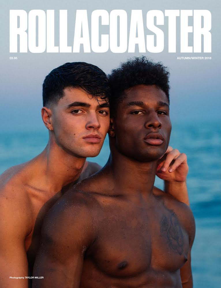 Models Noah Blaise and Leaon Gordon, shirtless and posed closely together by the sea on the cover of Rollacoaster magazine, photographed by Taylor Miller.