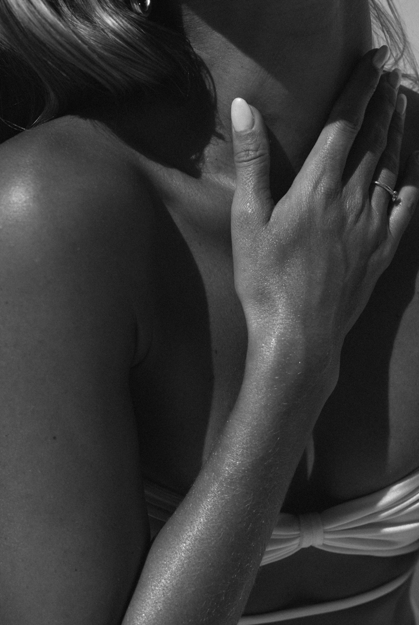 Black and white photograph of a guest relaxing poolside at MAJA Bali spa, highlighting wellness lifestyle and curated branding for boutique hotel and spa
