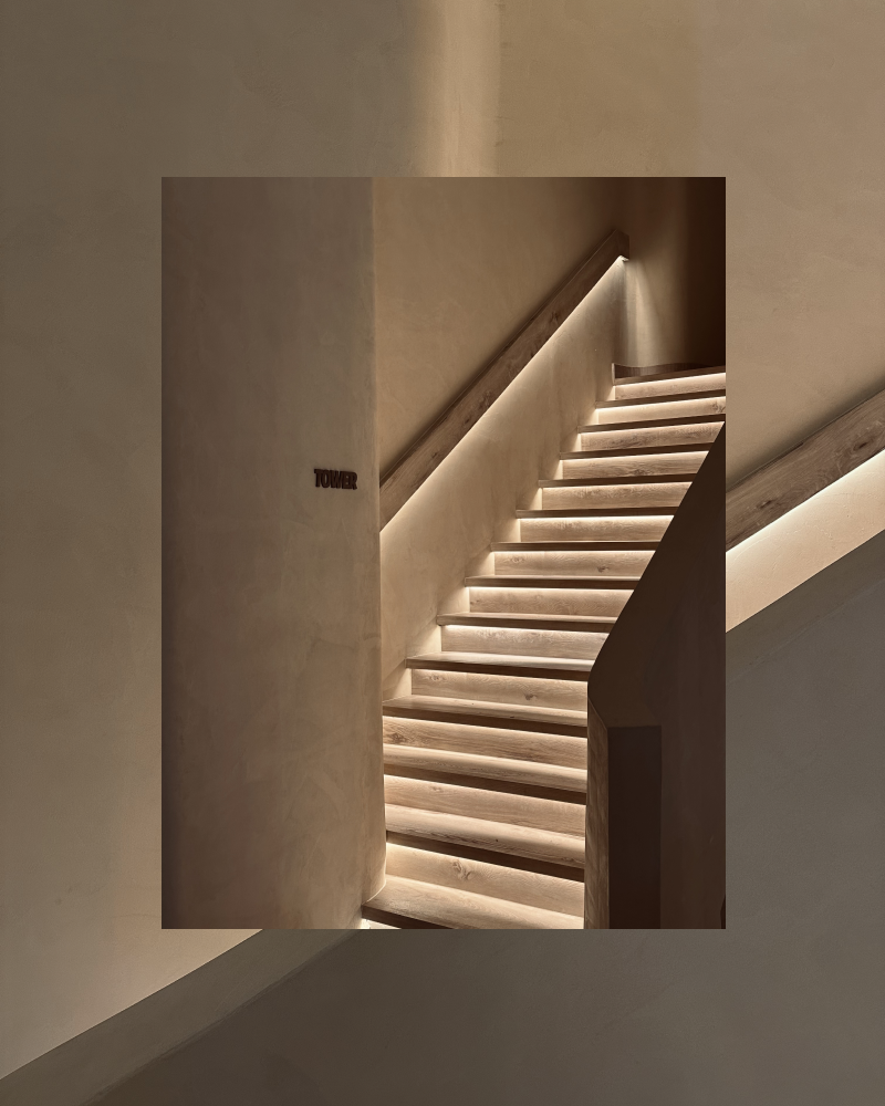 Posture Pilates Wayfinding and Stair Lighting – Brand Environment Design Dubai Minimal staircase with integrated LED lighting and “Tower” wayfinding plaque, part of Posture Pilates branded environment design in The Palm, Dubai