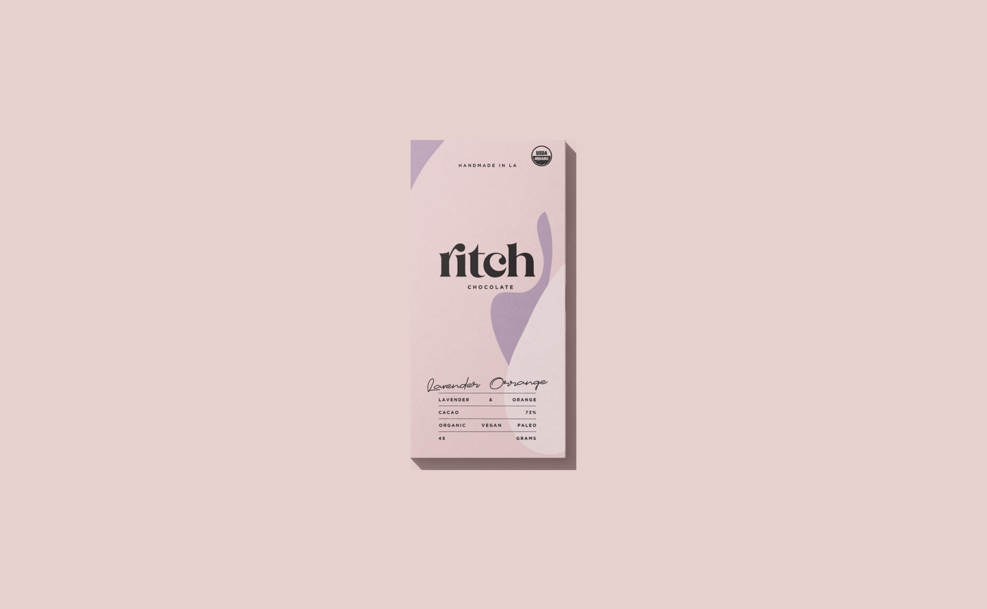 Minimalist packaging design for Ritch Handmade Chocolate’s Lavender Orange bar, featuring abstract shapes and soft neutral tones.