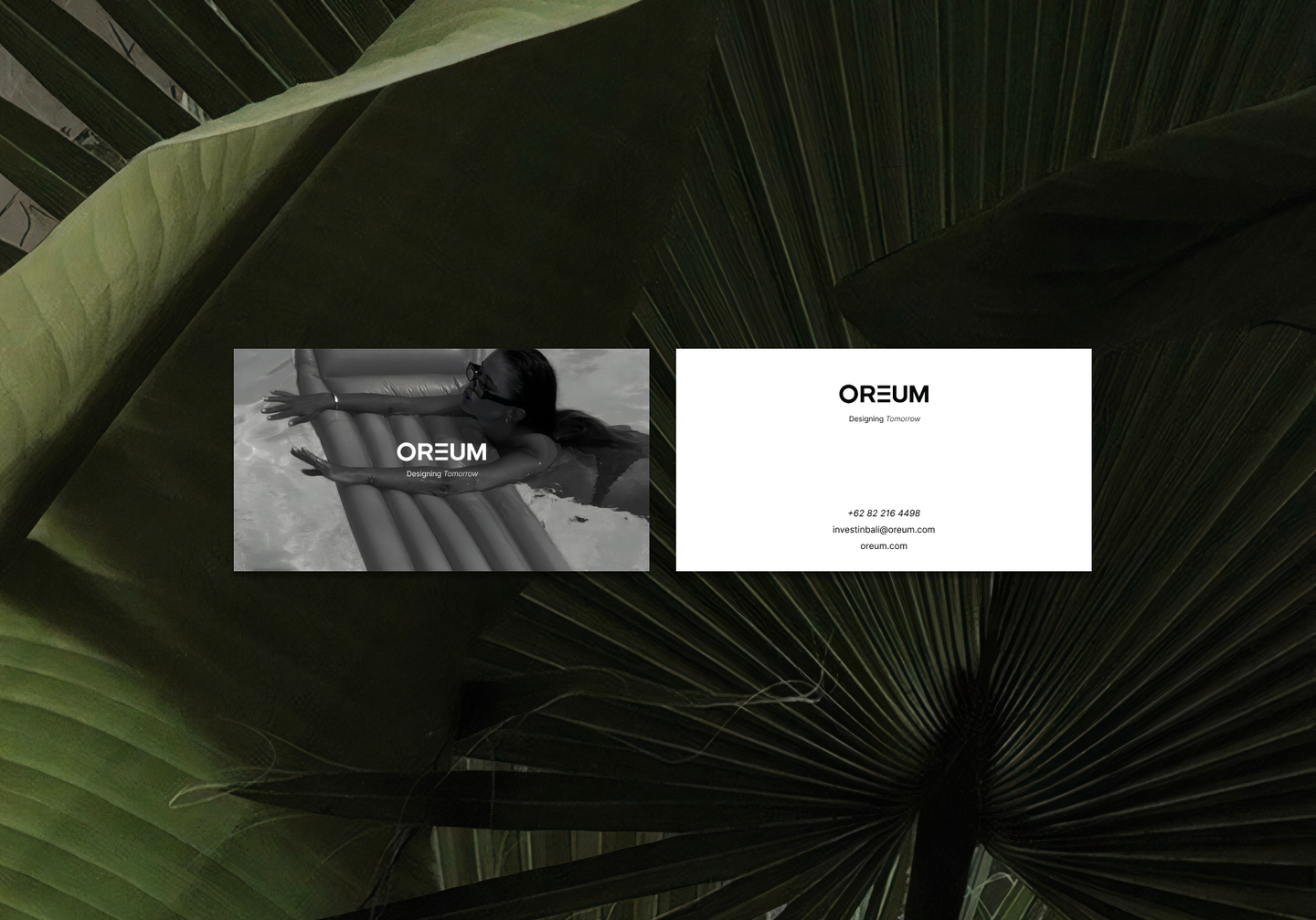 Minimalist OREUM business card design with bold logo, contact details, and lifestyle branding, placed over lush palm leaves; brand identity and collateral design by Eeze Studio for Bali wellness venture.